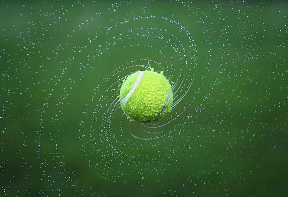 Free wet tennis ball spinning image, public domain sport CC0 photo.