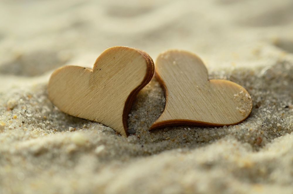 Free wooden hearts on the beach image, public domain CC0 photo.