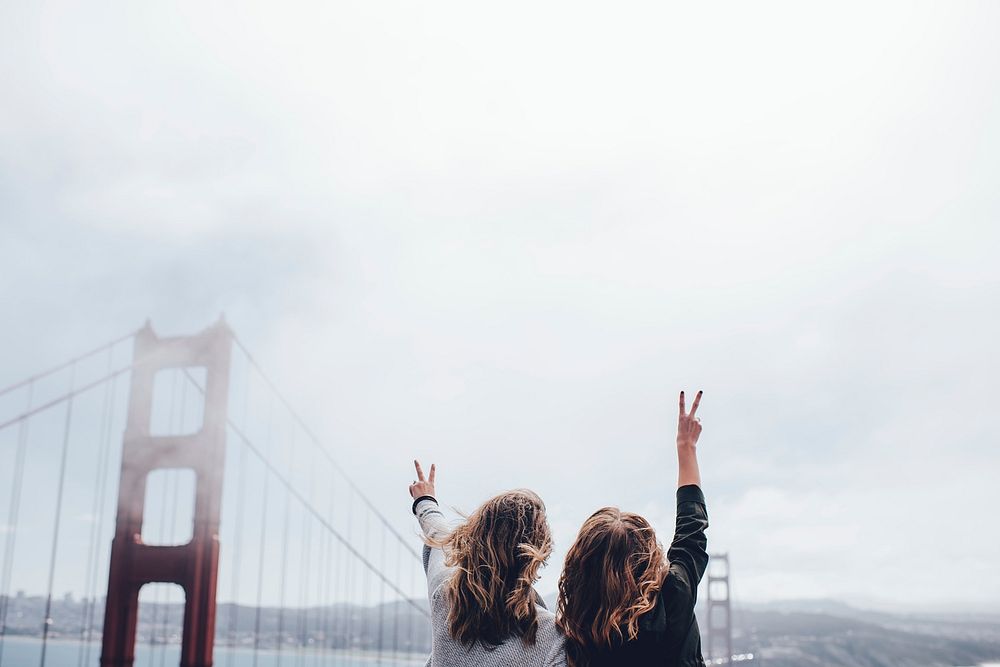 Free 2 women making peace sign near Golden Gate bridge image, public domain CC0 photo.