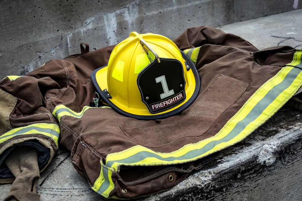 Free firefighter clothing on ground image, public domain CC0 photo.