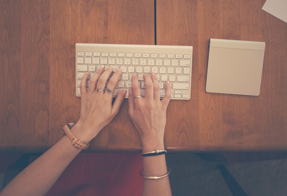 Woman typing on keyboard, free public domain CC0 photo.