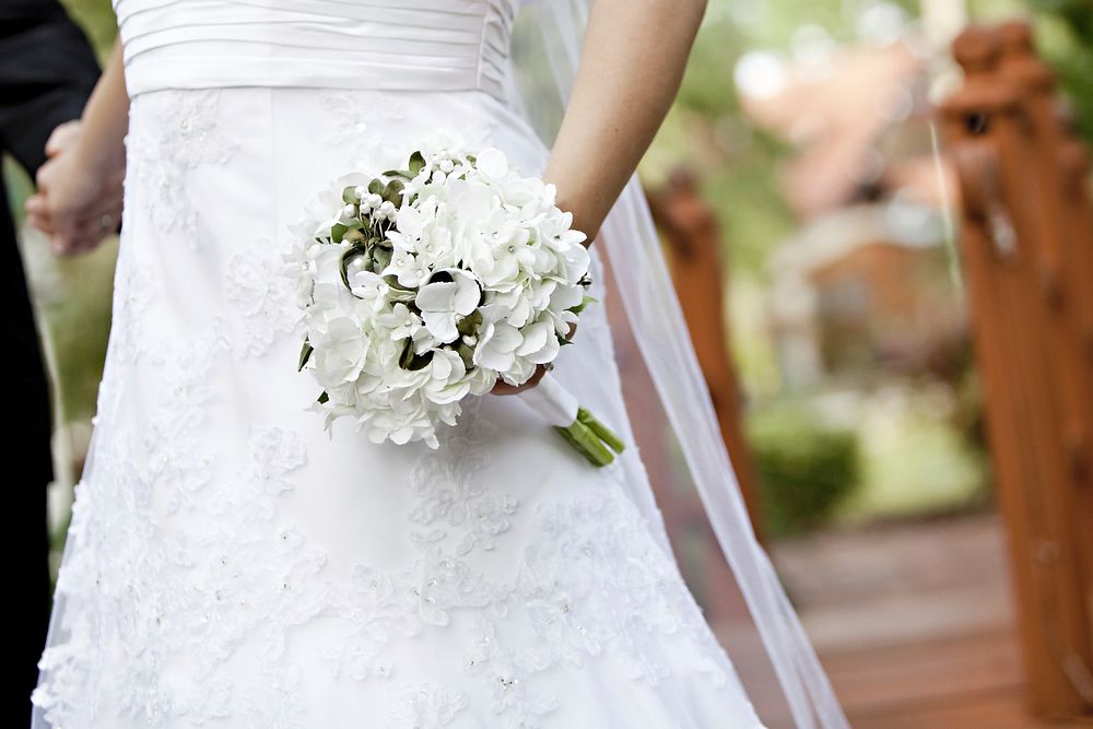 Free bride holding flower bouquet image, public domain CC0 photo.