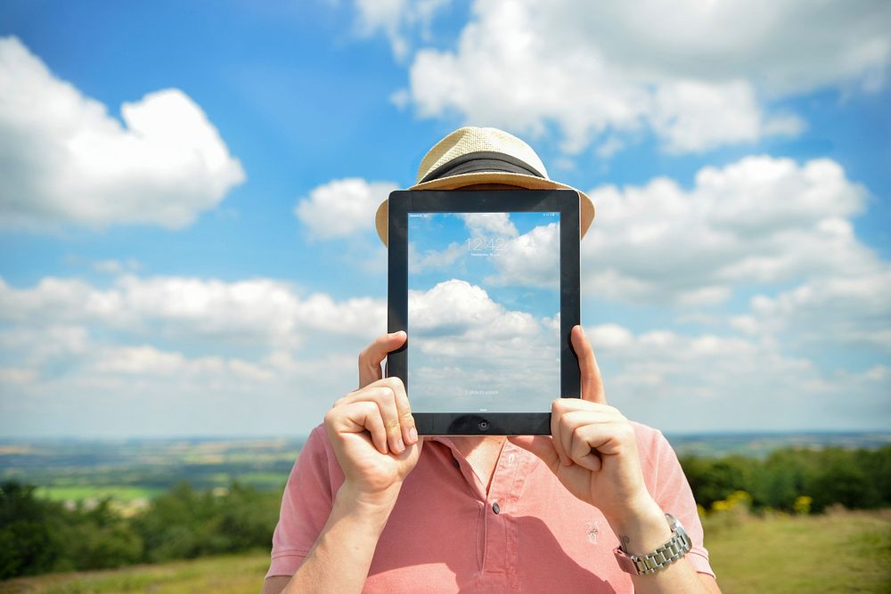 Free person covering his face with iPad image, public domain CC0 photo.