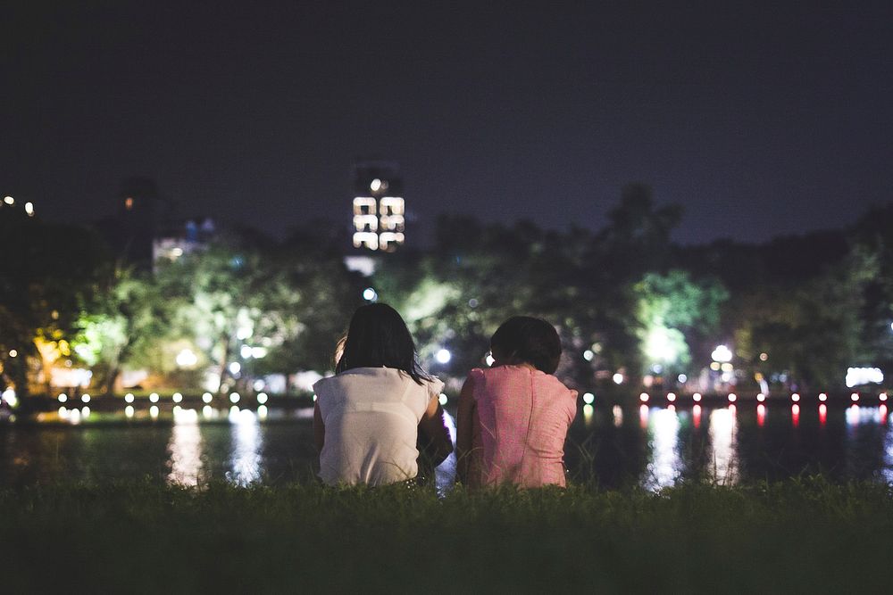 Free couple chilling by the water at night image, public domain CC0 photo.