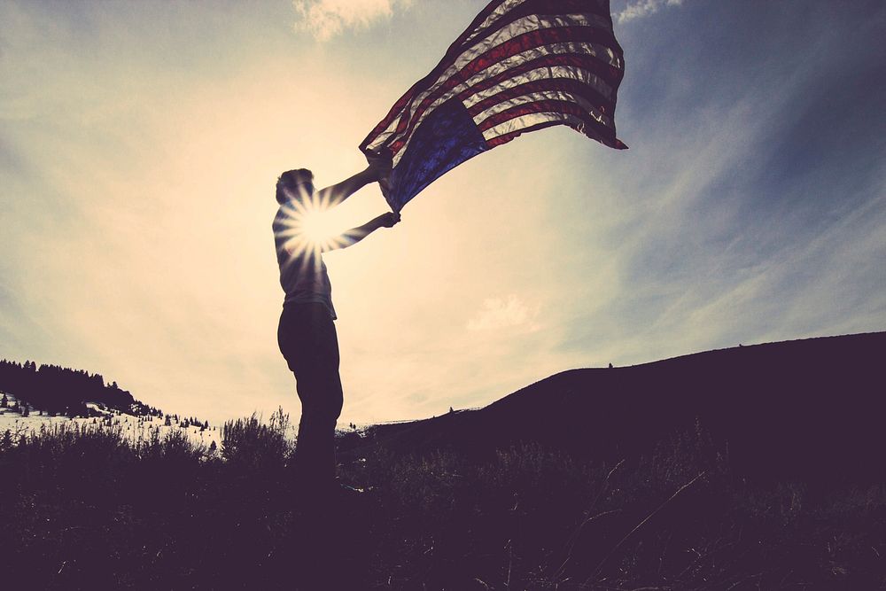Free person holding American fabric flag image, public domain CC0 photo.