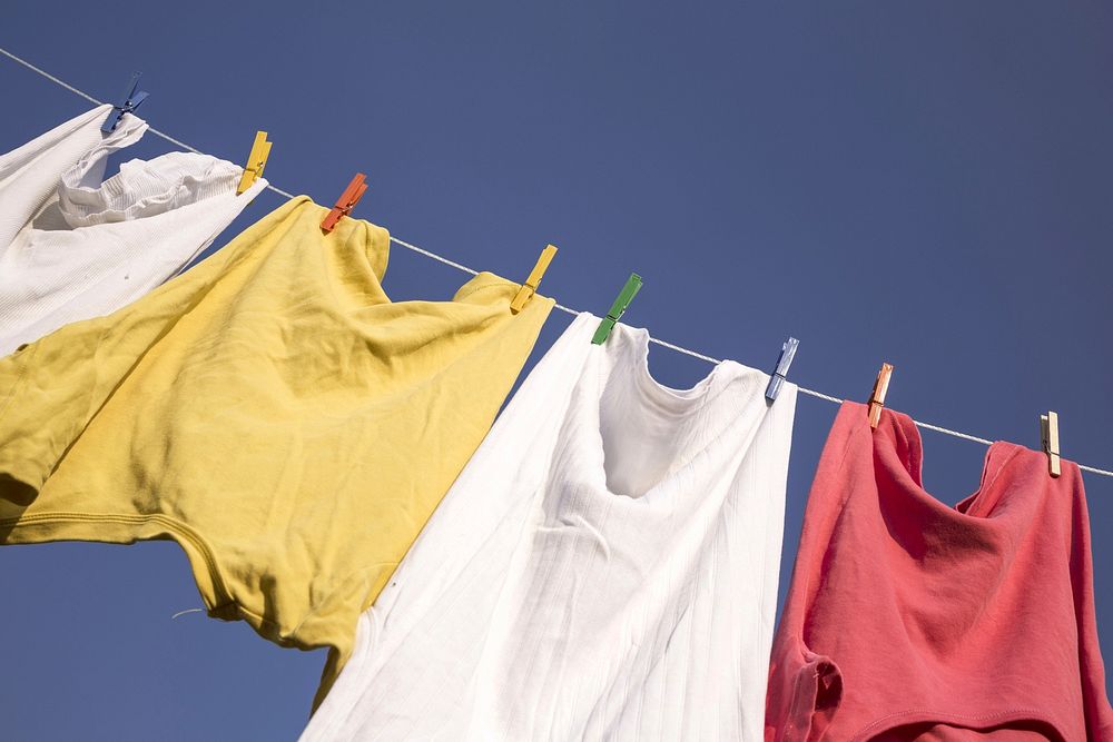 Clothes hanging against blue sky. Free public domain CC0 photo.