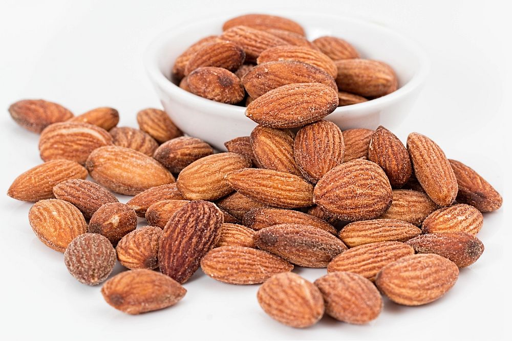 Free bunch of almonds on white background image, public domain nuts CC0 photo.