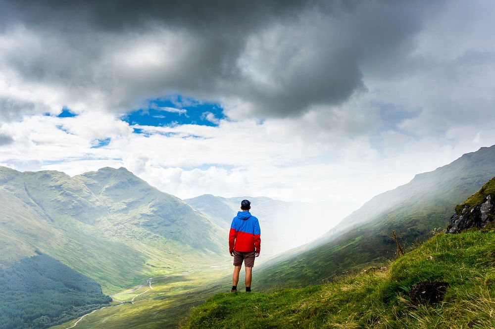 Man standing on mountain image, public domain travel CC0 photo.