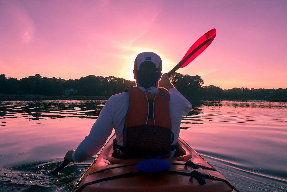 Free man kayaking in a river with beautiful sky image, public domain CC0 photo.