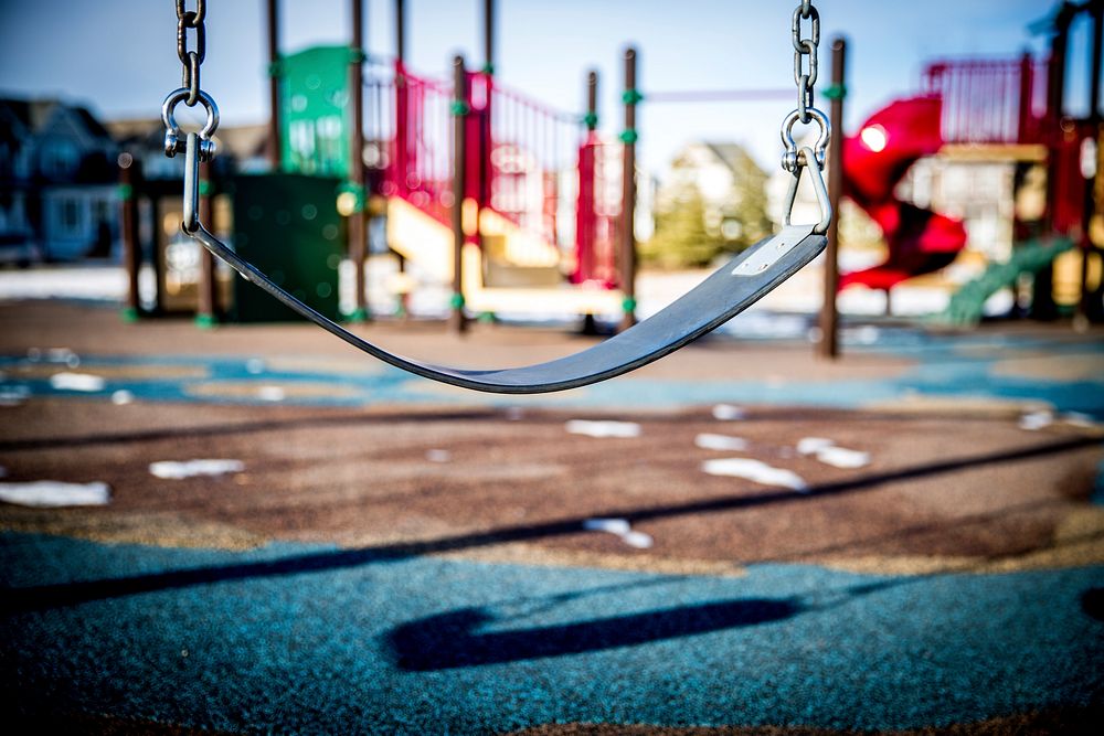 Swing in playground. Free public domain CC0 image.