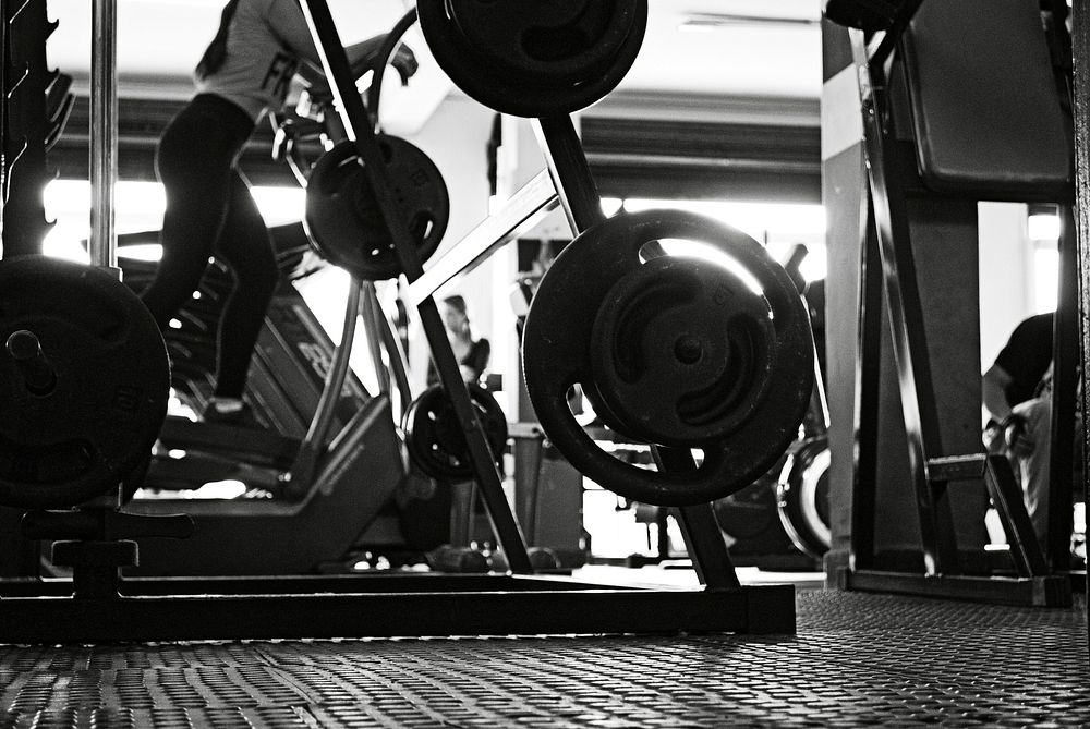Free weight training rack in black and white image, public domain fitness CC0 photo.