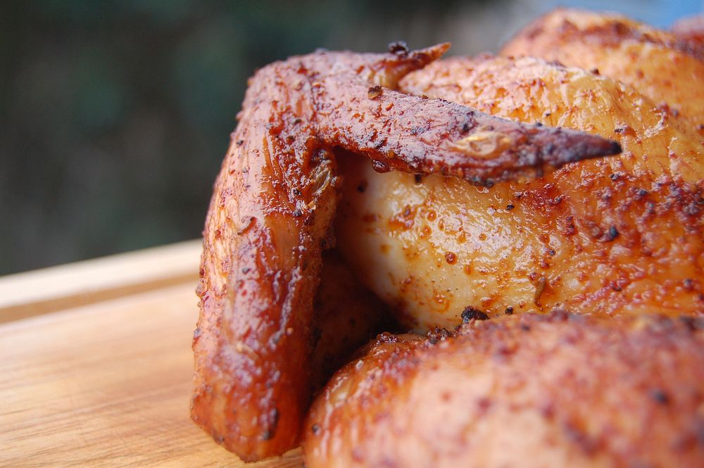 Free roasted chicken half. cutting board photo, public domain food CC0 image.