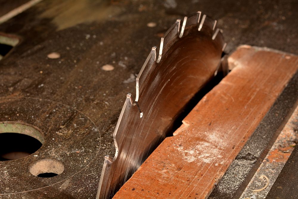 Free saw blade on wood table photo, public domain cutting CC0 image.