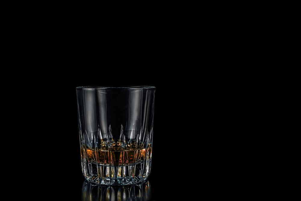 Free glass of whisky in black background photo, public domain beverage CC0 image.
