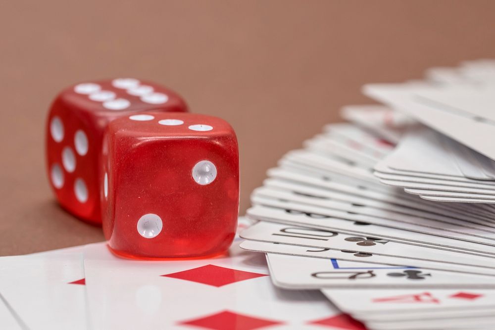 Red dice, gambling, table top game, free public domain CC0 photo.
