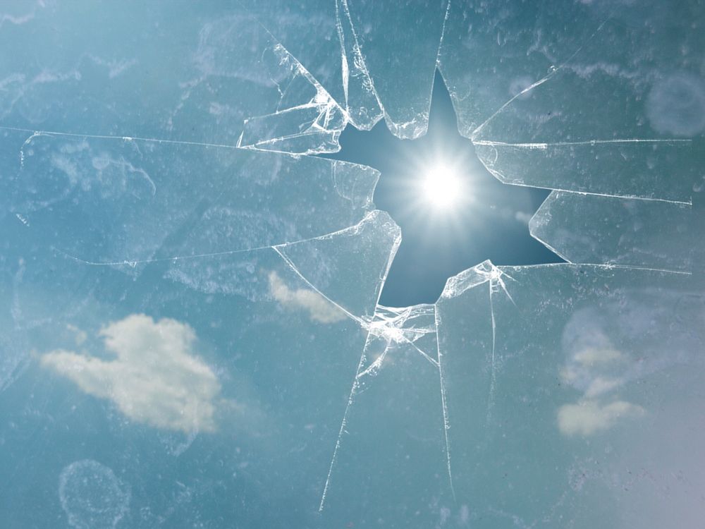 Free sky with sun flare through broken glass photo, public domain view CC0 image.