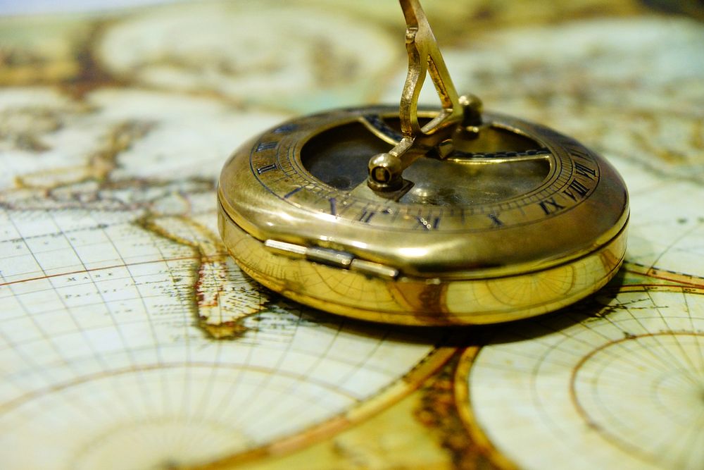 Golden compass on map, free public domain CC0 image.