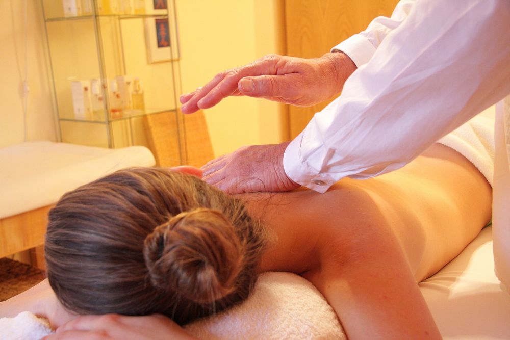 Free woman getting massage image, public domain relaxation CC0 photo.