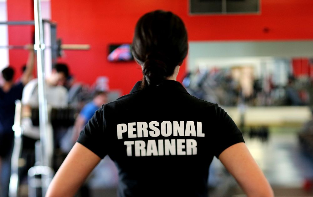 Free back of personal trainer in gym image, public domain fitness CC0 photo.