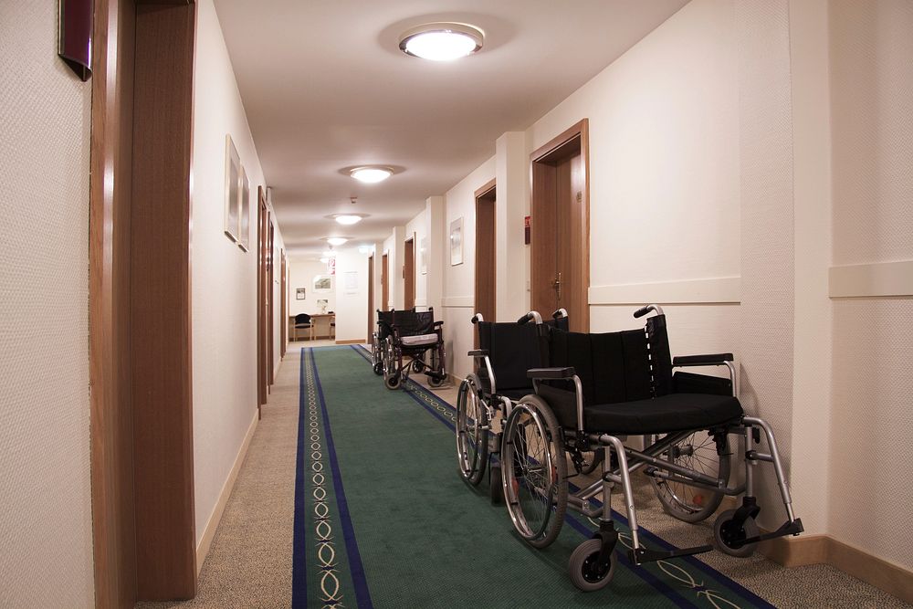 Free wheel chairs lined in a hallway image, public domain hospital CC0 photo.