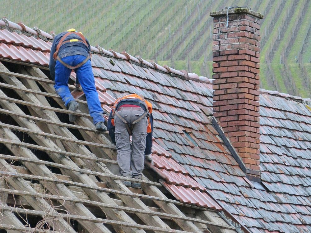 Free men fixing roof image, public domain human CC0 photo.