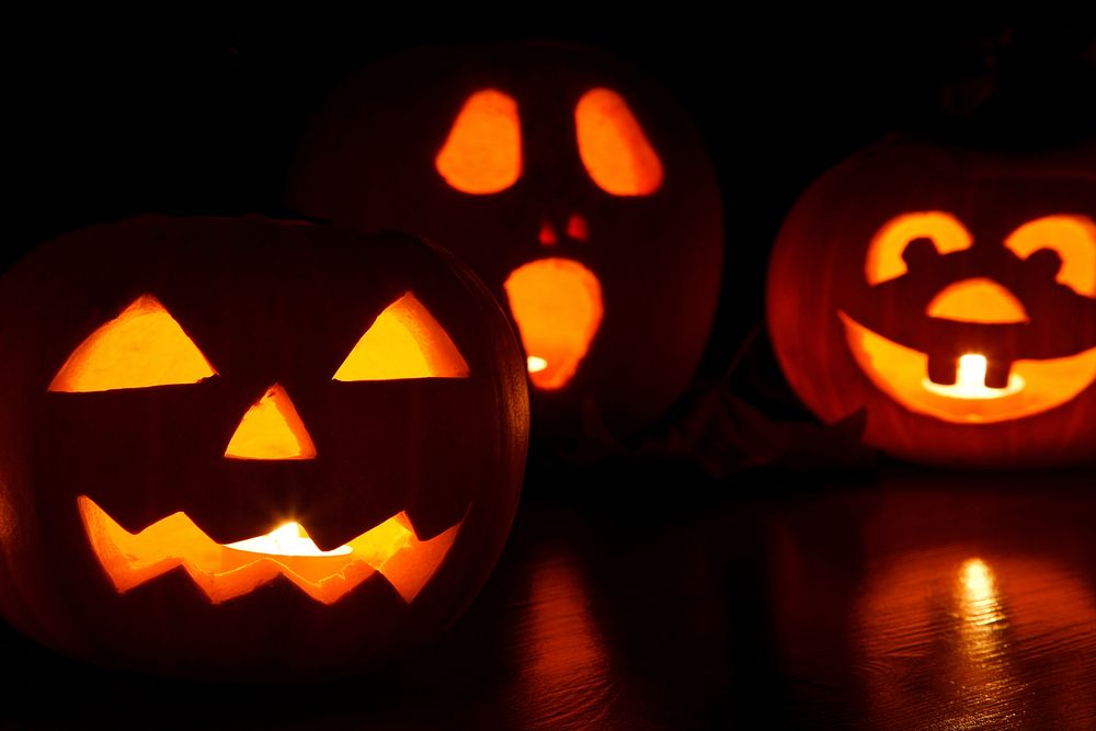 Free Halloween pumpkin with candles inside at night photo, public domain CC0 image.
