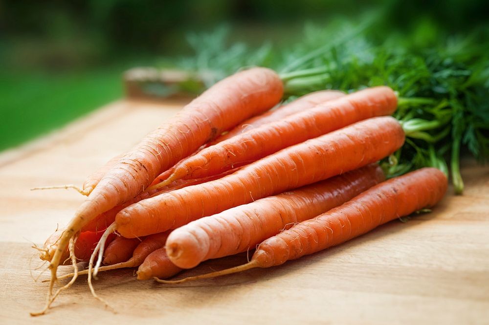 Free fresh baby carrots on cutting board photo, public domain vegetables CC0 image.