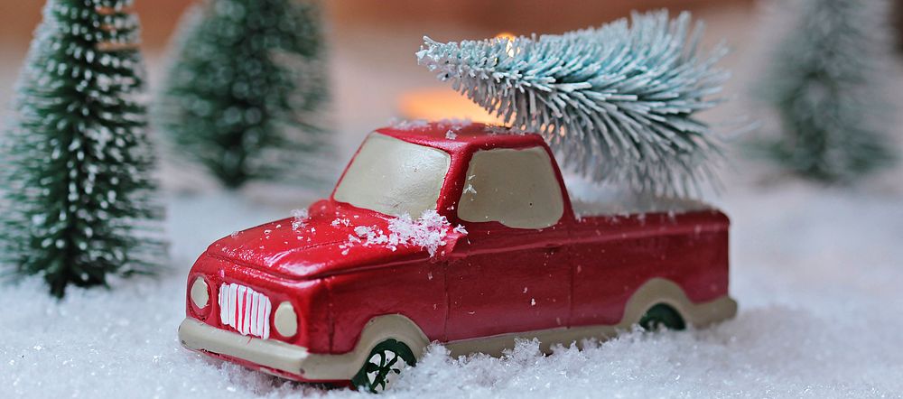 Free car model carrying Christmas tree image, public domain holiday CC0 photo.