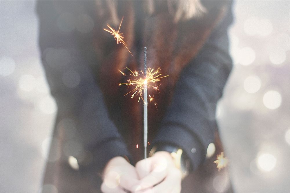 Free person holding burned sparkler in hand image, public domain CC0 photo.