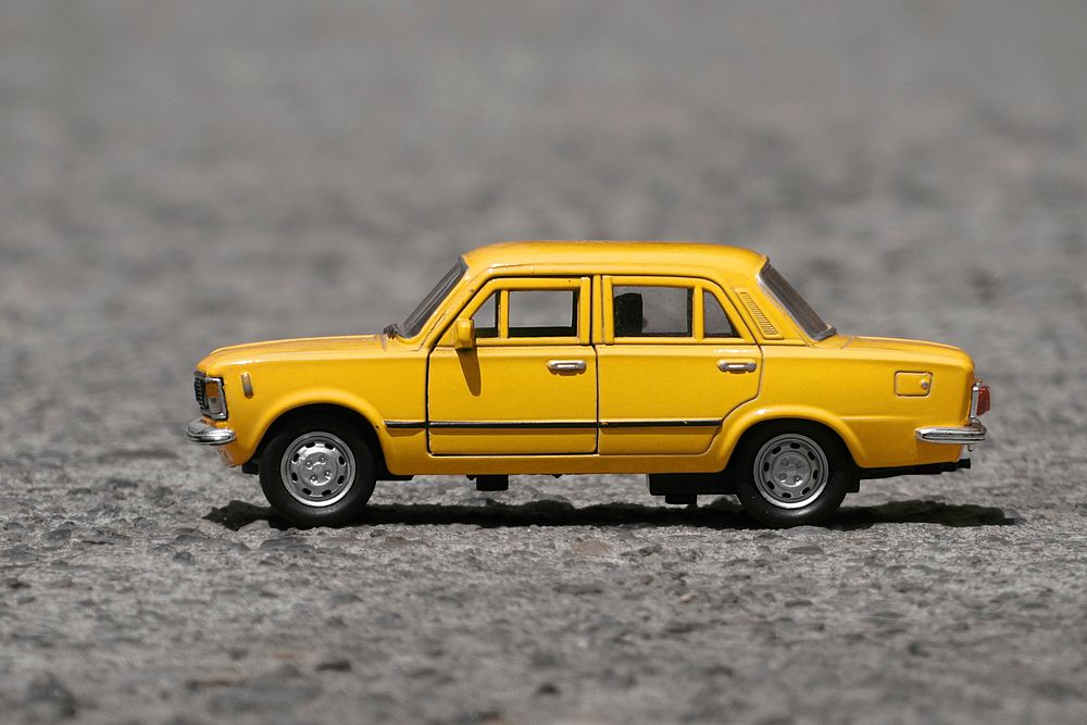 Miniature yellow vintage car. Free public domain CC0 photo.