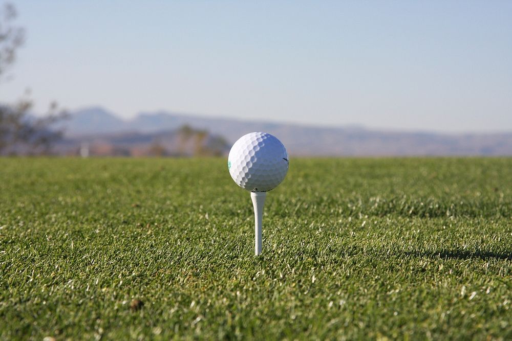 Free close up on golf ball on green grass photo, public domain sport CC0 image.