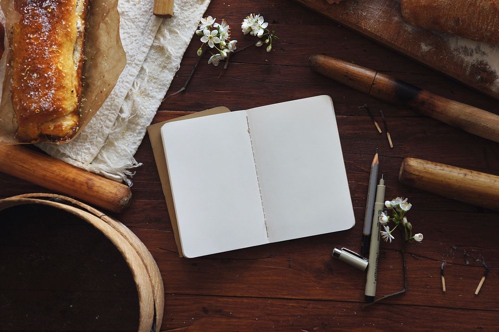 Free notebook with bread on table image, public domain food CC0 photo.