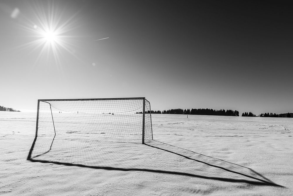 Free soccer goal on grass field in black and white image, public domain sport CC0 photo.