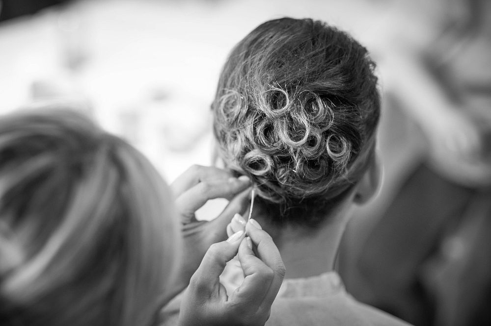 Hairdresser fixing bride's hair, free wedding public domain CC0.
