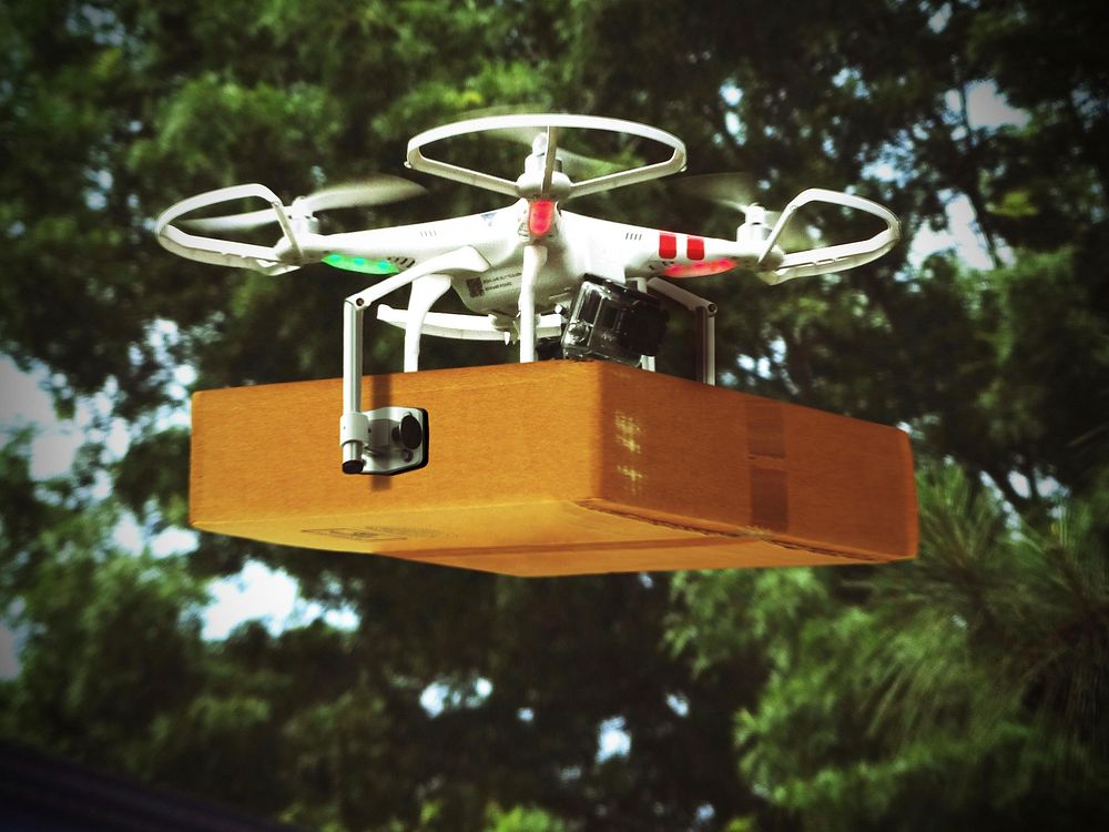 Free drone delivering package image, public domain technology CC0 photo.