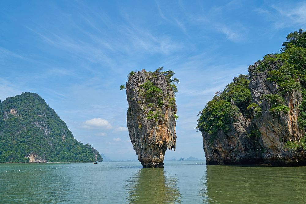 Island with cliff, rocks, caves, free public domain CC0 photo.