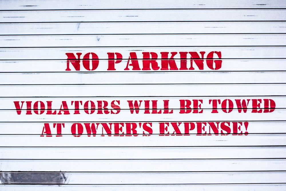 Free no parking paint on white wall image, public domain CC0 photo.