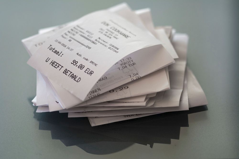 Receipts on table, free public domain CC0 image.