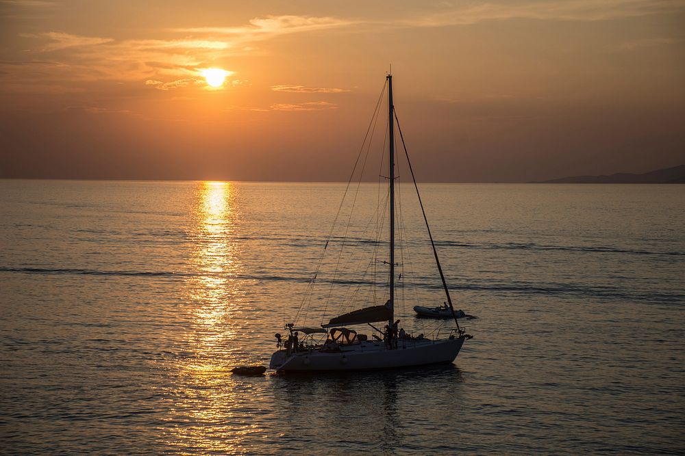 Free sailboat with beautiful sunset image, public domain CC0 photo.