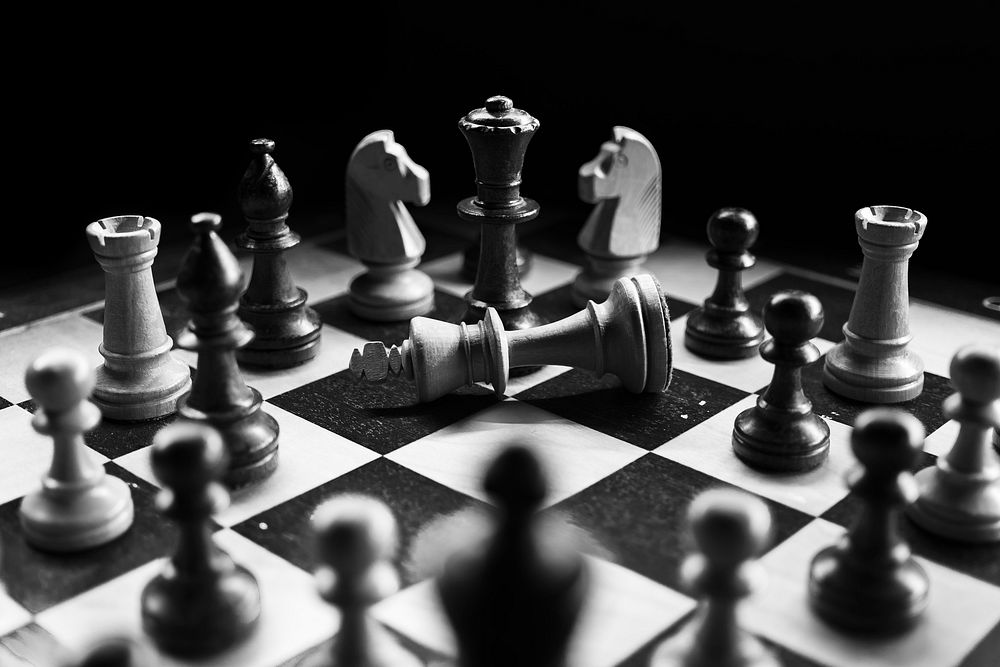 Free chess board with pieces, black and white photo, public domain game CC0 image.