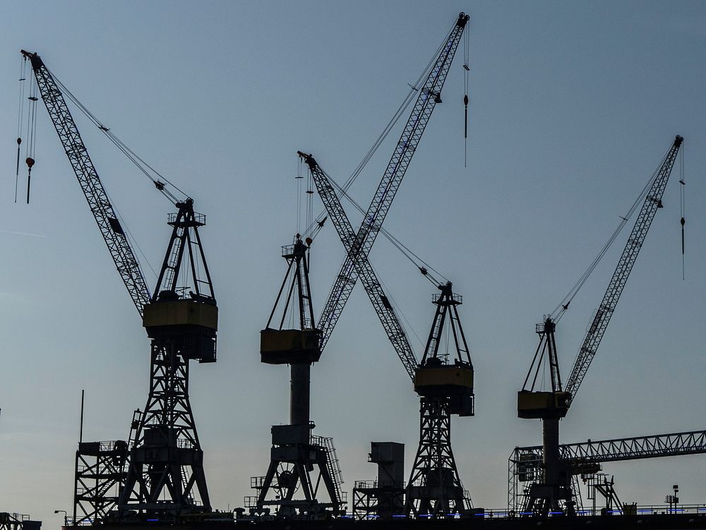 Cranes at port, silhouette, free public domain CC0 image.