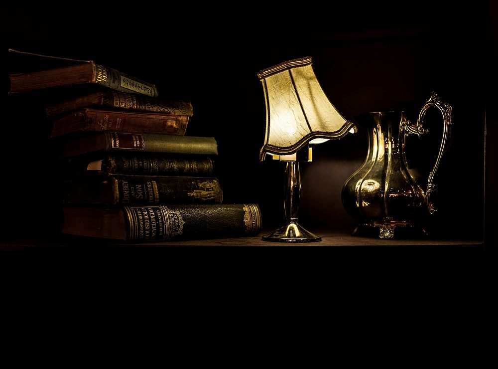 Free dark photo of vintage lamp and books, public domain antique CC0 photo.