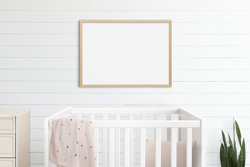 Picture frame mockup psd hanging in nursery room home decor interior