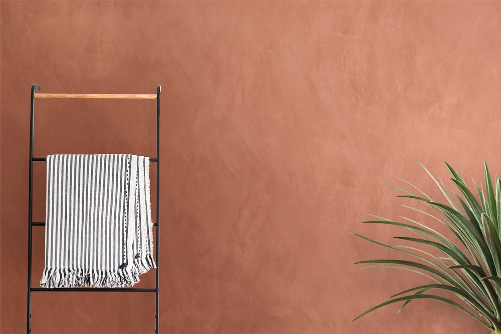 Bathroom wall mockup psd with plant and clothing rack 