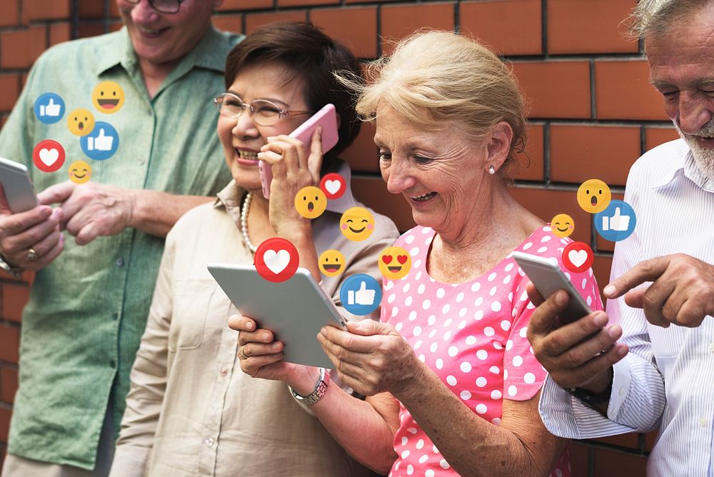 Diverse seniors using digital devices