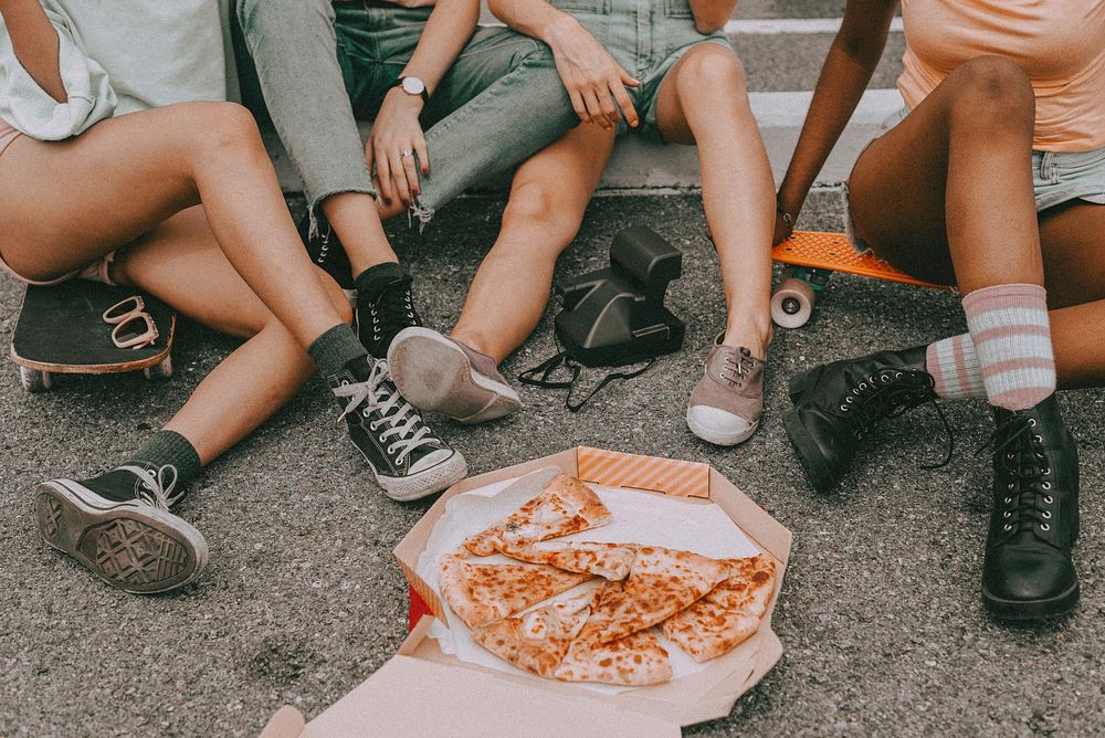 Girls hangout aesthetic, friends eating pizza while sitting on the ground