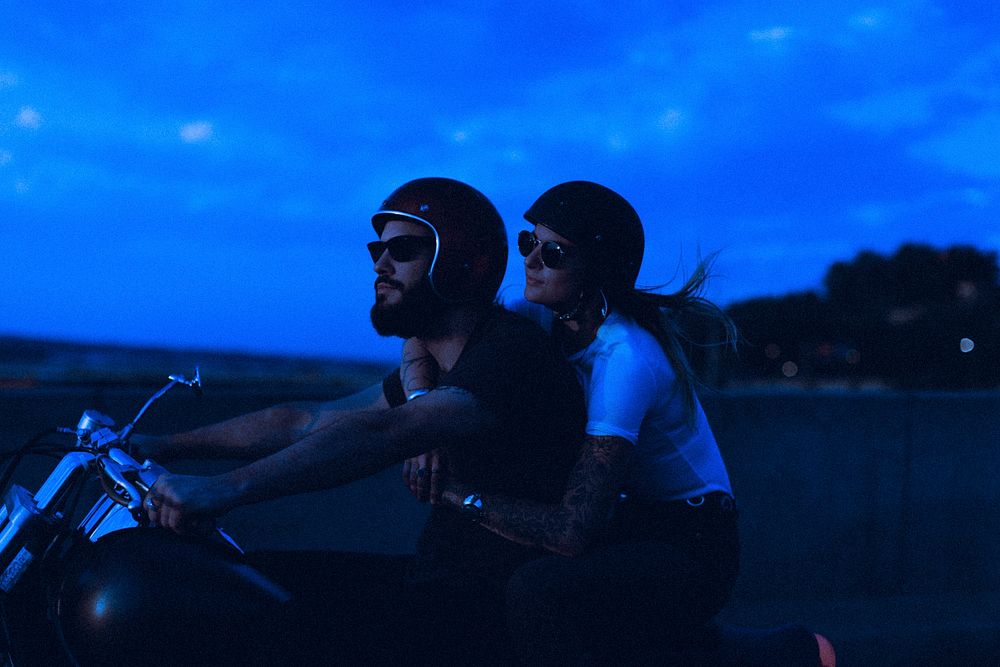Couple riding motorcycle, travel goal aesthetic in neon blue
