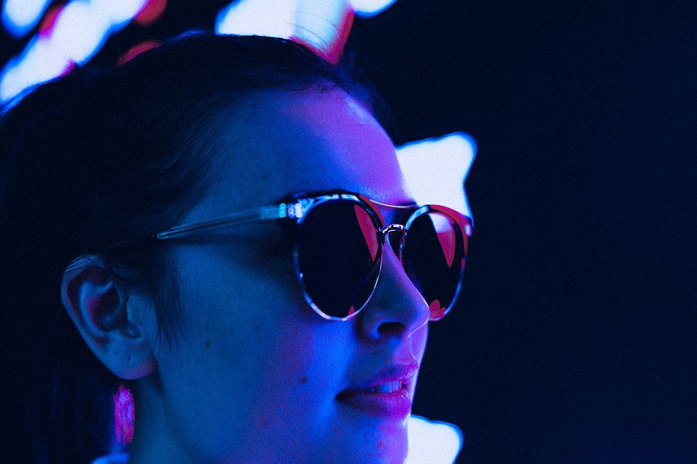 Woman wearing sunglasses, summer vacation in neon blue