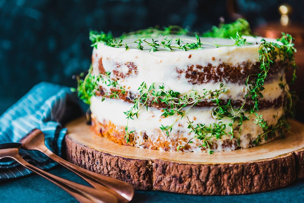 Delicious buttercream cake dessert with thyme