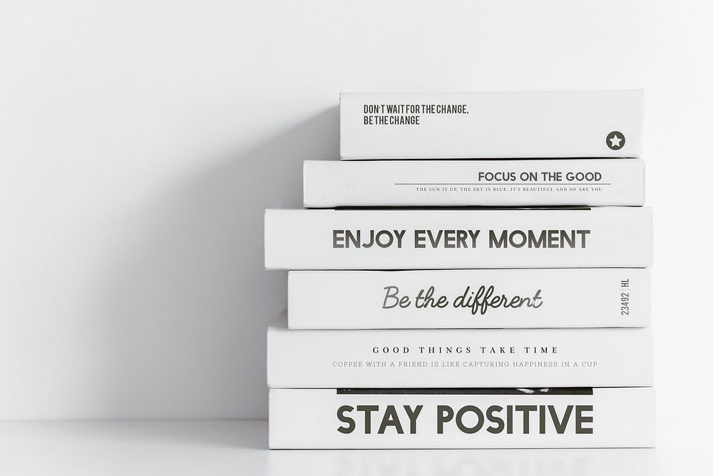Minimal books background, aesthetic positive quotes in white